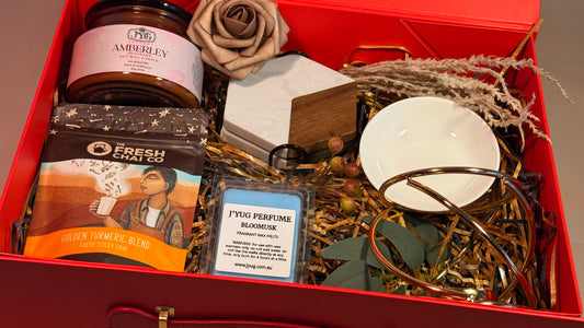 Luxury gift hamper in red magnetic box with cream ribbon and floral decoration