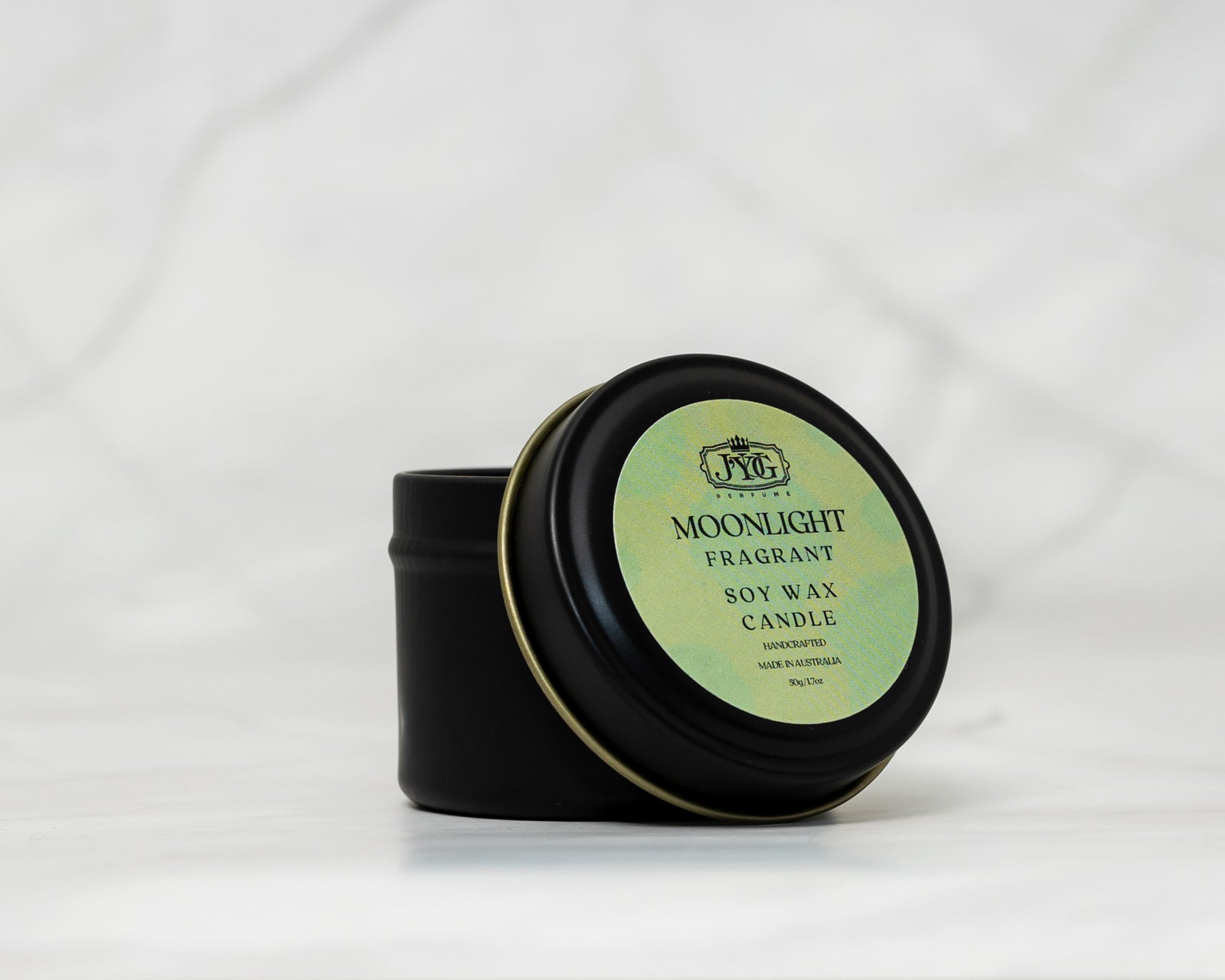 Four signature scented candles in elegant tins - J'YUG sample set